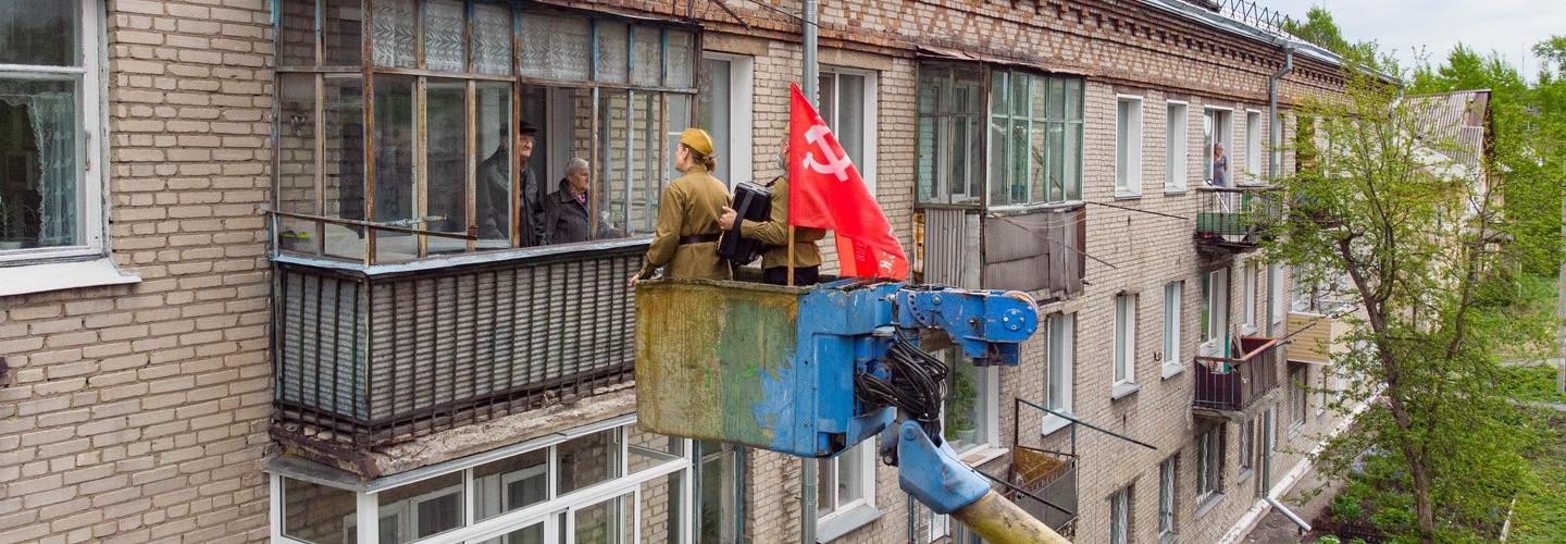 Песня к балкону: ветеранов поздравляют с автовышки в Новосибирске